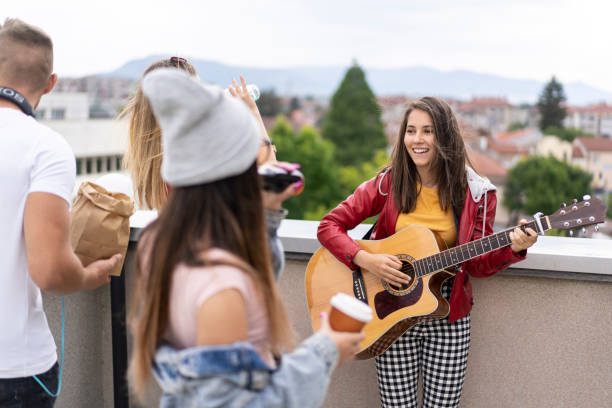 istock Singing and playing guitar with friends 1291177720