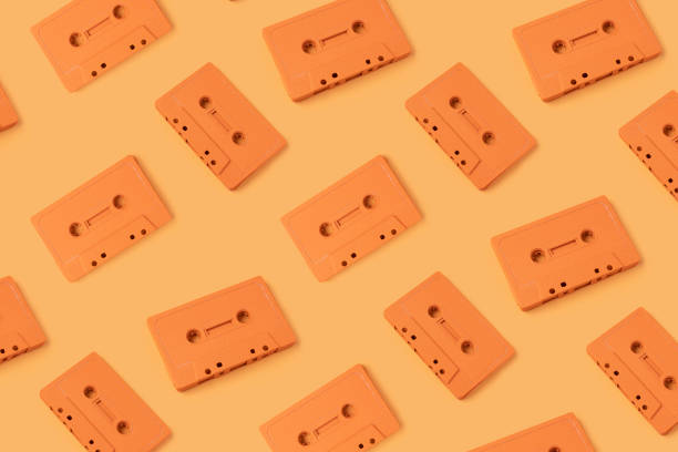 istock Pattern made with retro audio cassettes on modern orange background 1291177898