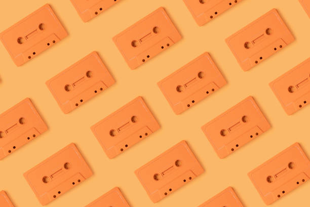 istock Pattern made with retro audio cassettes on modern orange background 1291177983