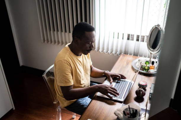 istock Senior man using laptop at home 1291179333