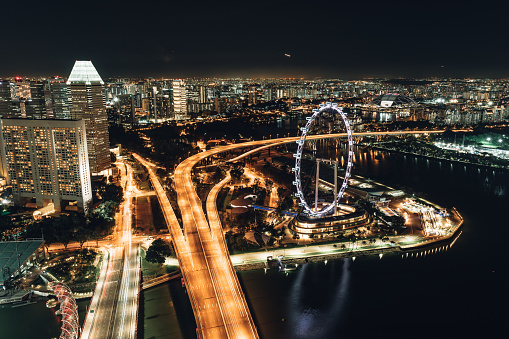 Aerial view of singapore with ferris wheel. Night time.