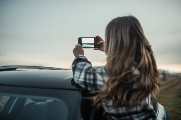 istock young woman taking a picture from a car 1291180583