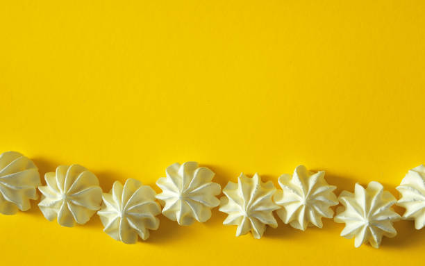 istock Meringues on yellow background 1291181544