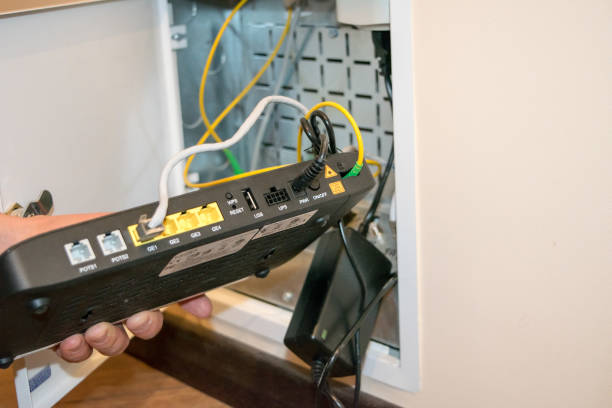 istock Open box to router, human hand human hand is holding black router 1291183466