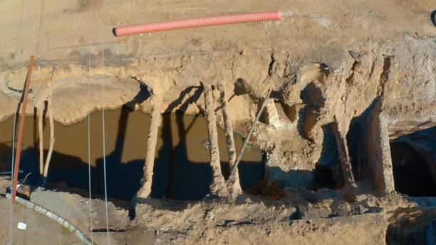 istock Laying and replacing pipelines in a deep dug ditch 1291183785