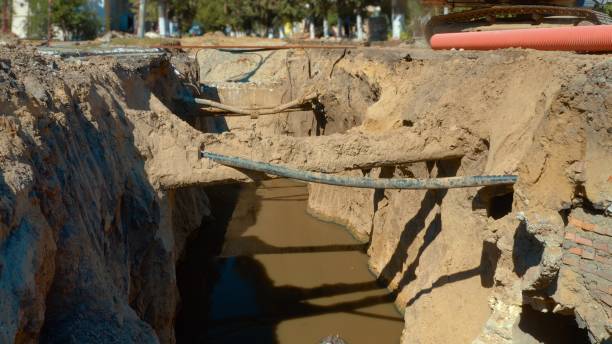 istock Laying and replacing pipelines in a deep dug ditch 1291183855