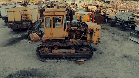Junkyard of old damaged construction machinery waiting for recycling