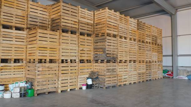 istock Warehouse with a stack of wooden crates 1291183957
