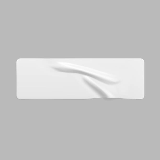 istock White glued crumpled rectangle sticker mock up. Blank white adhesive paper or plastic sticker label with wrinkled and creased effect. Template label tag close up. 3d realistic vector 1291183966