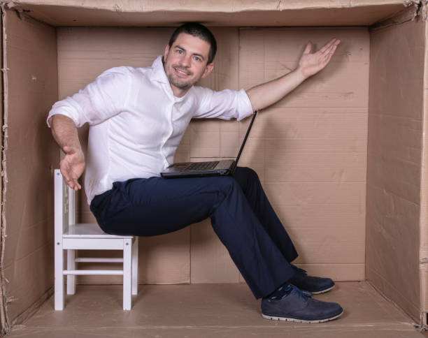 istock businessman seated in his cramped office satisfied with his work 1291185021