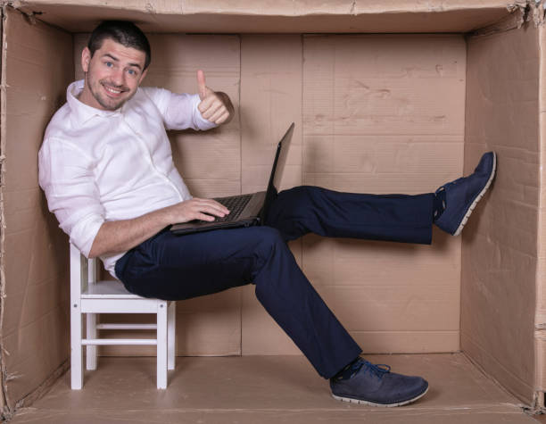 istock businessman seated in his cramped office satisfied with his work 1291185133