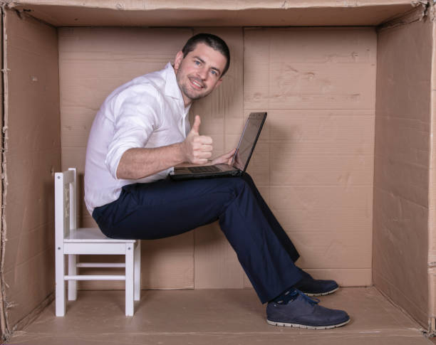 istock businessman seated in his cramped office satisfied with his work 1291185164