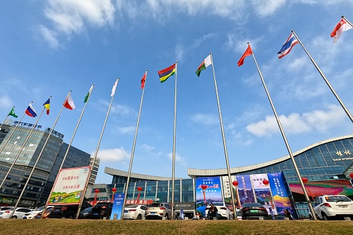 China,Guilin,Dec 09, 2020,\nChina-ASEAN Expo Tourism exhibition.\nThis is the exterior of the exhibition,\nThe national flags of various countries are fluttering in the wind.\nThe exhibition is held in Guilin Fourth Quarter of each year.