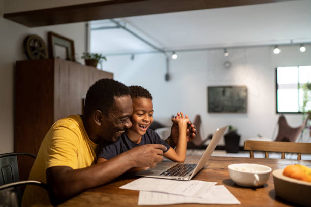 istock Grandfather helping grandson studying or working at home 1291187487