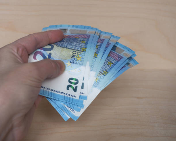 istock Hand holding Euro notes, European Union 1291188141