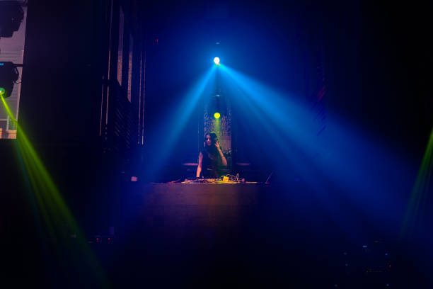 istock DJ on stage in disco night club mixing techno music beat 1291189250