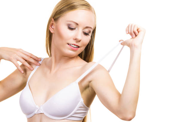 istock Young woman holding bra strap 1291192328