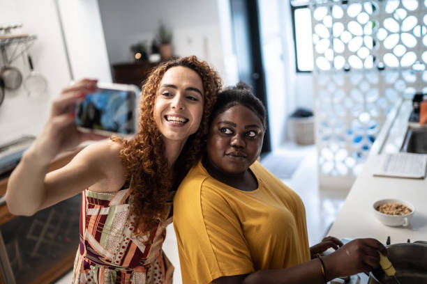 istock Friends doing a video call or taking a selfie while cooking at home 1291194818