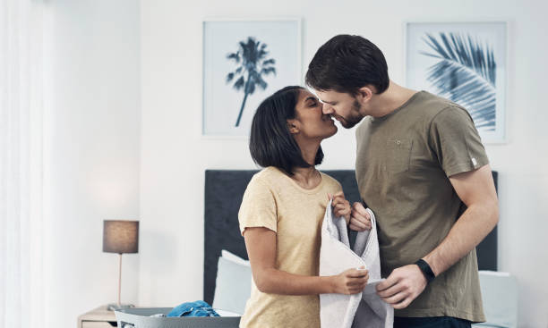 If ever you needed motivation to do the laundry… Shot of an affectionate young couple doing laundry together at home indian couple kiss stock pictures, royalty-free photos & images