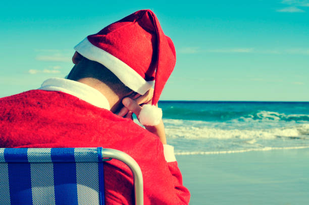 istock santa claus taking a nap on the beach 1291196596