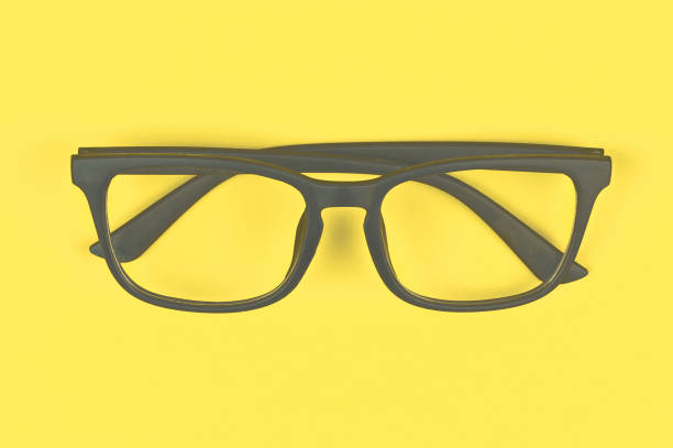 istock Glasses with transparent lenses with diopters on a yellow background. stylish accessory. Concept of trendy colors - gray and yellow 1291196749