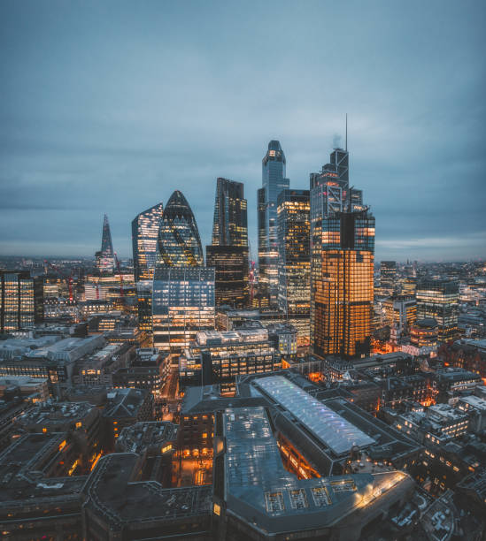 The City of London Skyline at Night, United Kingdom Aerial panoramic view of The City of London cityscape skyline with metropole financial district modern skyscrapers after sunset on night with illuminated buildings and cloudy sky in London, UK city of london photos stock pictures, royalty-free photos & images