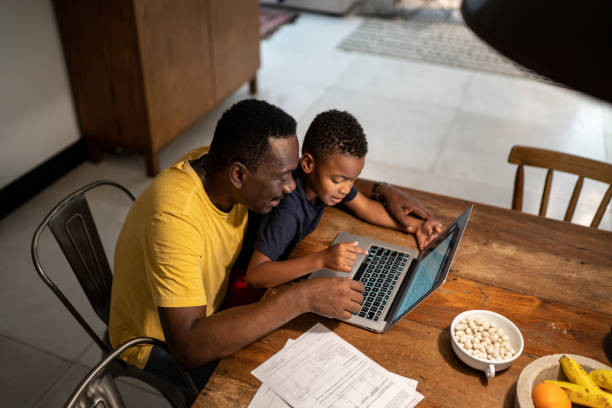 istock Grandfather helping grandson studying or working at home 1291202778