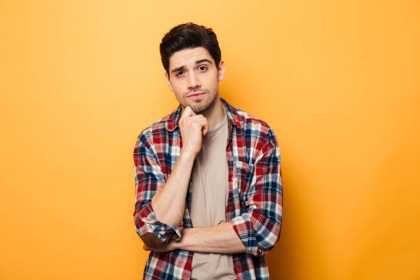 istock Portrait of a pensive young man looking at camera 1291202896