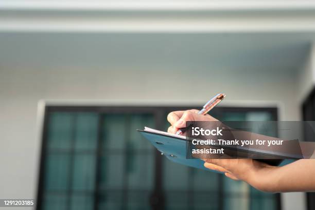 Writing Down On Paper For Quality Verify Concept Stock Photo - Download Image Now - Quality Control, Examining, Building Exterior