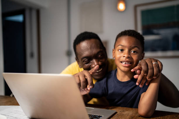istock Grandfather helping grandson studying or working at home 1291203321