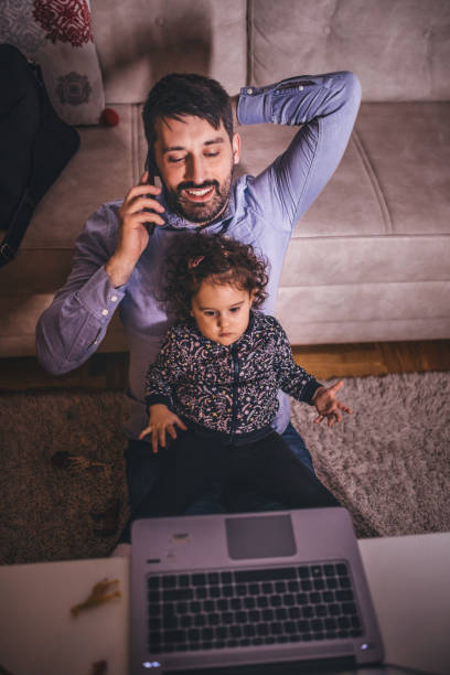 istock Fahter is showing his daughter things on a laptop 1291204882