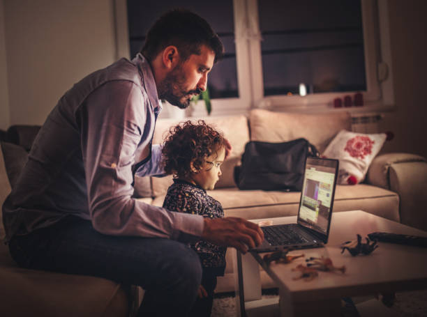 istock Fahter is showing his daughter things on a laptop 1291205761