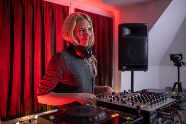 istock Beautiful DJ girl mixing electronic music 1291207680