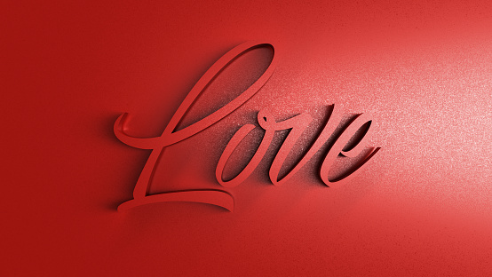 The word love written in slanted on glossy red background