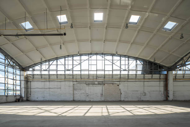 istock Wall of huge empty industrial warehouse. White interior. Unique soviet architecture. Hemispherical reinforced concrete load bearing roof. Modern building. 1291208312