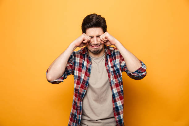 istock Portrait of a sad young man crying loud 1291208314