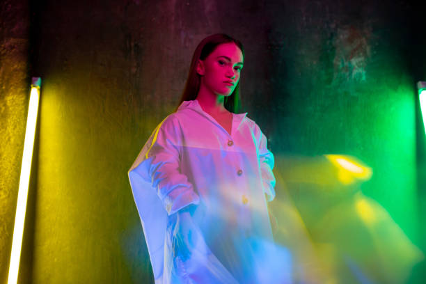 istock Caucasian female inclusive model posing on studio background in neon light 1291208553