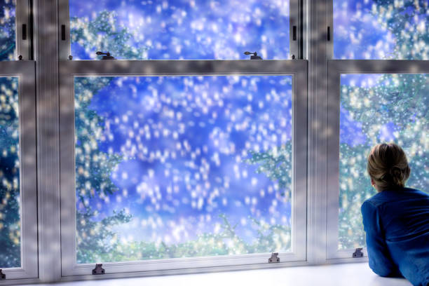 istock Winter background with falling snow outside the window. 1291211646