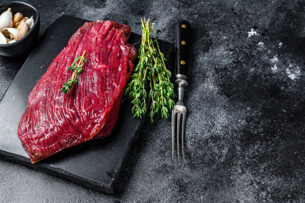 istock Venison raw steak from wild meat. Black background. Top view. Copy space 1291212667