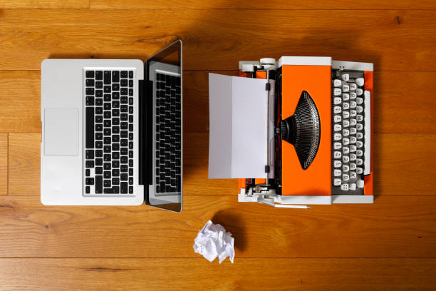 istock Digital and analog – Laptop and 70s Typewriter 1291212990