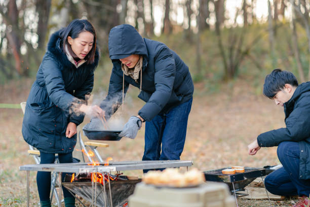 istock Friends preparing breakfast at camp site in winter 1291220472