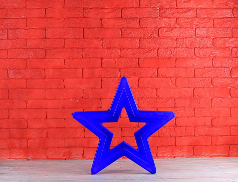 blue christmas star on red brick wall background