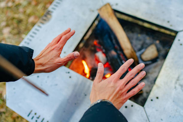 istock Man warming his hands up on camp fire in winter 1291222797