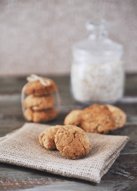 istock Oat cookies with ingredients on wooden background. 1291223290