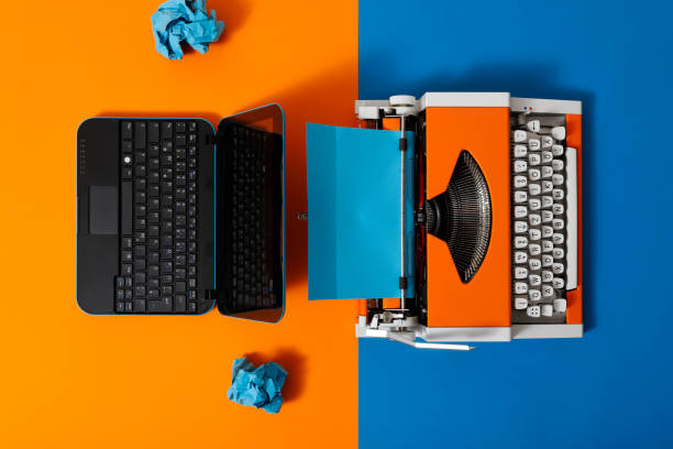 istock Digital and analog – Laptop and 70s Typewriter 1291224126
