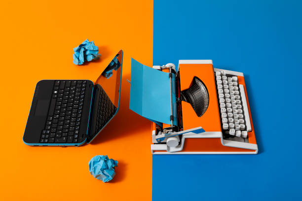 istock Digital and analog – Laptop and 70s Typewriter 1291225328