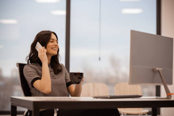istock Young attractive business woman using a phone during a Coffee break 1291227688