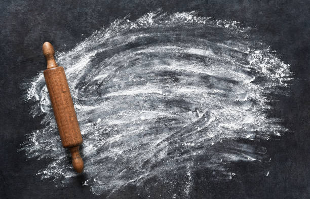istock Scattered flour and rolling pin on the stone kitchen table. View from above. Cooking baking. 1291229896