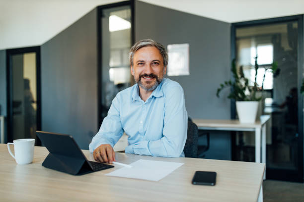 istock Dressed in light blue shirt, at office. 1291232223