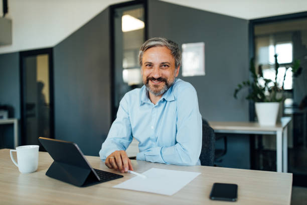 istock Men posing in his new office. 1291232226